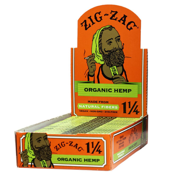 A display box of Zig-Zag Organic Hemp rolling papers, showing the front and side panels with an orange background, green accents, and an illustration of a bearded man.