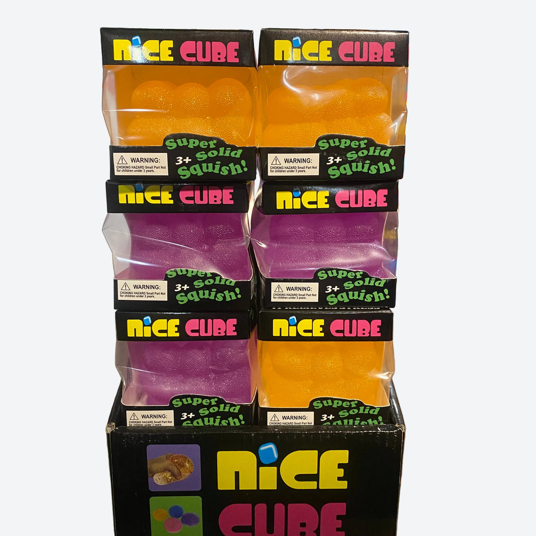 A retail display box stacked with four packs of 'Nice Cube' squishy toys, showing orange, purple, and yellow squeeze balls inside clear plastic packaging with black and colorful labels.