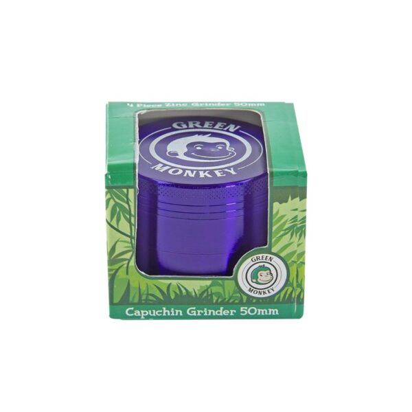 A 50mm purple metal capuchin grinder by Green Monkey, shown inside its green retail packaging box with a clear window.