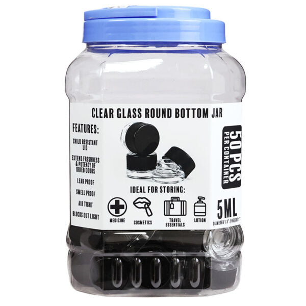 A 5 mL clear glass round bottom jar with a blue screw-on lid, shown on a white background. The front label reads 'CLEAR GLASS ROUND BOTTOM JAR' and '5 ML', with product features and icons printed on the front.