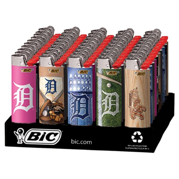 A BIC branded display tray holding multiple lighter-shaped items in different sports team designs, including pink Detroit Tigers, blue Detroit Tigers, green Detroit Tigers, and natural wood Tigers graphics, with red tops visible on each item.