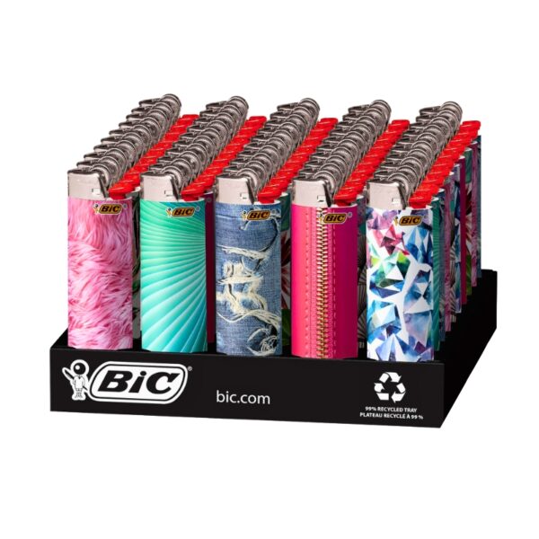 A BIC branded display tray holding multiple patterned plastic lighter bottles. The lighter bodies show various colorful designs including pink feathers, turquoise swirls, blue-and-white animal print, hot pink, and a multicolor geometric pattern, while the lighter tops are red.
