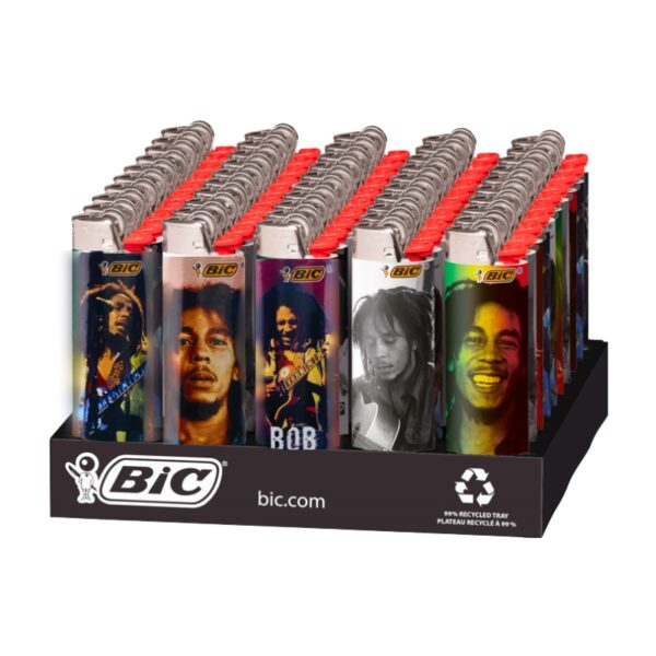 A BIC retail display tray holding multiple lighter packs, each pack featuring a different Bob Marley portrait in various color treatments. The display stand is black with the BIC logo and website printed on it.