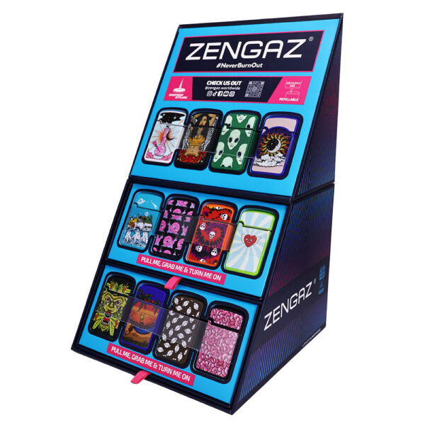 A Zengaz 'NeverBurnOut' display stand showcasing various custom lighter options. The black and blue triangular stand features multiple rectangular panels showing different wrap designs, including floral, skull, and abstract patterns, with pink pull tabs labeled 'PULL TO REGRAPE AND TURN IT ON'.