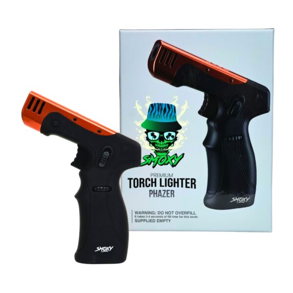 A black and orange handheld torch lighter shown in front of its retail box. The lighter has a black textured grip and a metallic orange tip, with the brand name 'Smoxy' visible near the base.