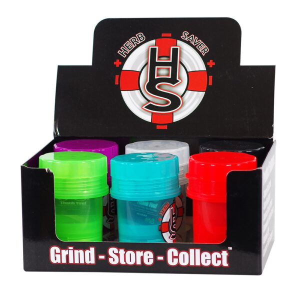A black cardboard display box for Herb Saver herb grinder containers, showing four small cylindrical grinder jars in green, blue, red, and purple, with a white, red, and black HS logo on the display back panel.