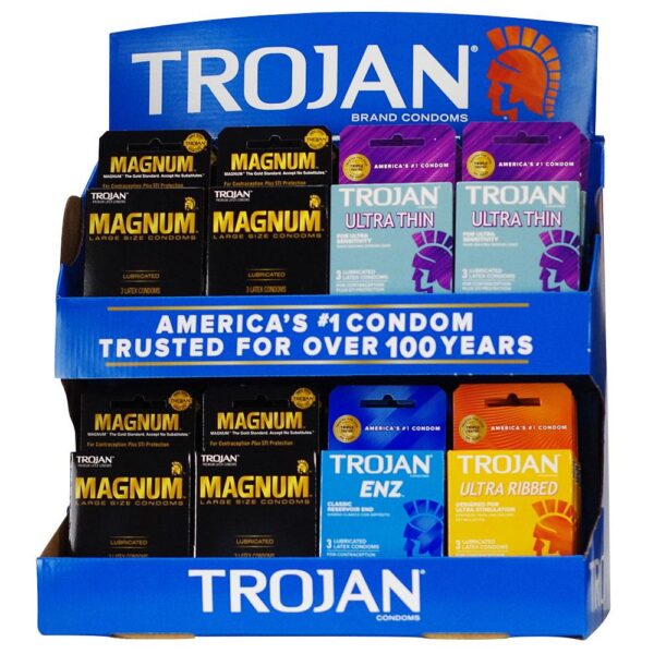 A blue Trojan brand display stand filled with assorted condom packages, including Magnum, Trojan Ultrathin, Trojan Enz, and Trojan Ultra Ribbed.