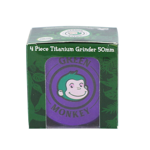 A boxed 4-piece titanium grinder, 50mm, featuring a green and purple design with a cartoon monkey logo. The packaging is shown against a plain white background.