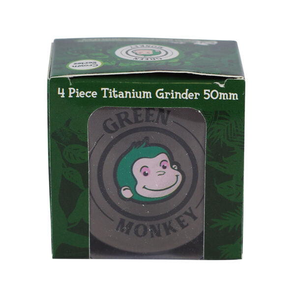 A boxed 4-piece titanium grinder, 50mm, featuring the Green Monkey brand logo on the front window.