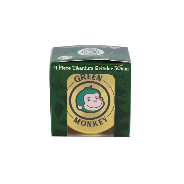 A boxed Green Monkey 4 Piece Titanium Grinder 50mm, featuring a dark green box with a prominent yellow circular logo containing the Green Monkey brand name and cartoon monkey illustration.