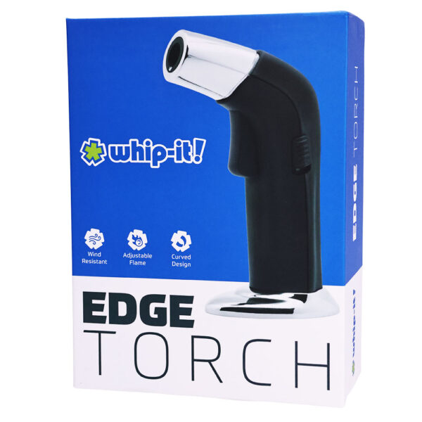 A boxed product shot for a whip-it! Edge Torch. The retail box is blue and white, featuring a large photo of the black-and-silver handheld torch on the front, with the whip-it! logo and product name printed prominently.