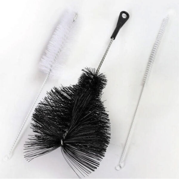 A cleaning brush set on a white background, featuring a black bristle brush with a metal handle and black loop, two white flexible cleaning brushes, and a white plastic loop.