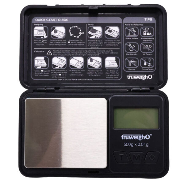 A compact digital pocket scale in its open carrying case, showing a stainless steel weighing platform on the left and a small LCD display on the right with the truweighO logo. The inside lid contains printed quick start guide and tips.