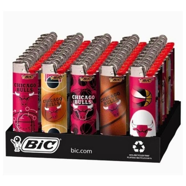 A display of BIC Chicago Bulls lighters arranged in rows on a black retail tray. The lighters feature various Chicago Bulls team graphics in pink, yellow, brown, and red, with silver metal tops and red tips.