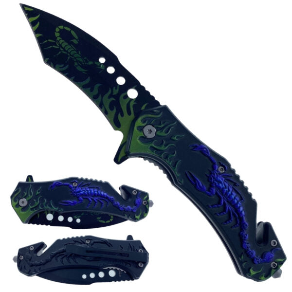 A folding pocket knife shown open and closed twice on a plain white background. The knife has a black handle and blade with green flame-like graphics and blue/purple scorpion illustrations.