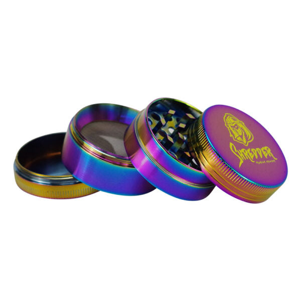 A four-piece herb grinder with an iridescent rainbow finish, shown with the lid removed to reveal the grinding teeth. The lid features a gold logo that reads 'Sapporo'.