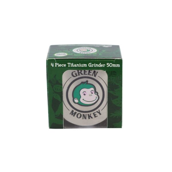 A green cardboard box for a 4-piece titanium grinder, 50mm, featuring the Green Monkey brand logo with a cartoon monkey face on a white label.