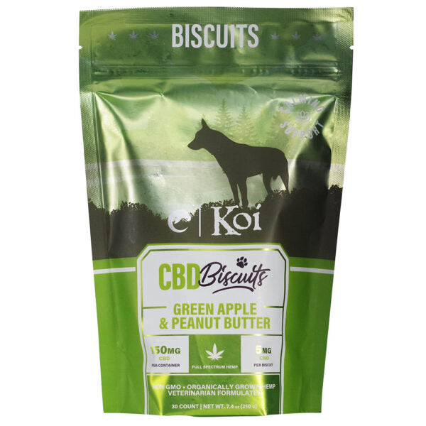 A green stand-up pouch of Koi CBD Biscuits dog treats, featuring a black dog silhouette on a grassy background with the text 'BISCUITS', 'CBD Biscuits', and 'GREEN APPLE & PEANUT BUTTER'.