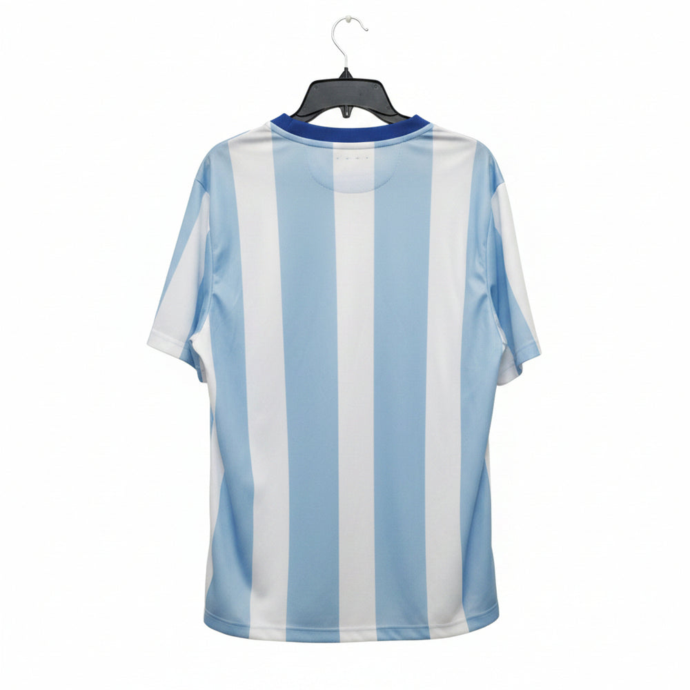 A light blue and white vertically striped short-sleeve t-shirt hanging on a black hanger against a wooden door background.