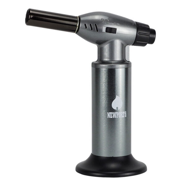 A metallic silver and black torch lighter with a cylindrical base and a flame nozzle, featuring the Newport brand logo on the front.