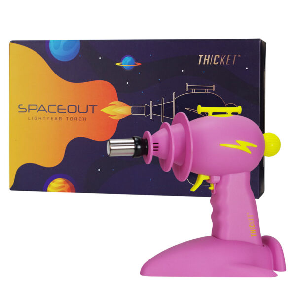 A pink Space-Out Lightyear Torch toy lighter with a yellow nozzle and yellow lightning bolt accents, shown in front of its dark purple and orange space-themed packaging box.