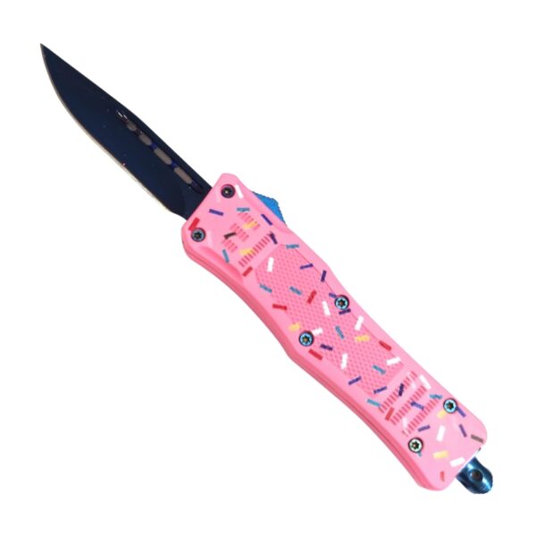 A pocket knife with a black blade and a pink handle decorated with a sprinkle pattern, shown against a plain white background.