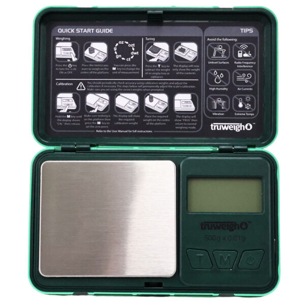 A portable digital pocket scale in a dark green case, shown open with the lid displaying a quick start guide and tips. The scale features a stainless steel weighing platform on the left and a small LCD screen on the right, with the truweigh brand name visible on both the inside lid and the base.