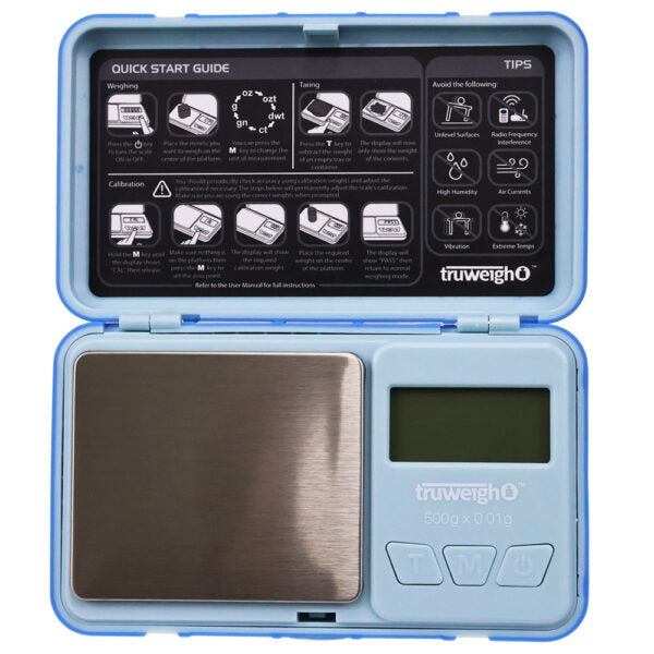 A portable digital pocket scale in a light blue plastic case, shown open with the top lid displaying a quick start guide and the bottom half housing a brushed stainless steel weighing platform and LCD screen.