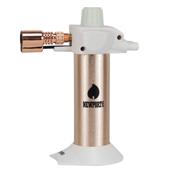 A portable torch light with a metallic rose gold body, white plastic top and base, and a copper-colored gas connector, shown on a plain white background. The Newport brand logo is printed on the center of the body.