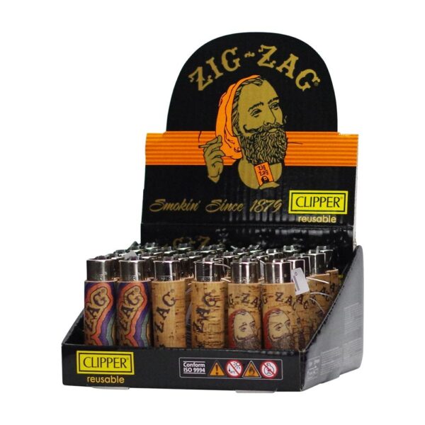 A retail display box filled with reusable clipper lighters. The display features a black backing with a large 'ZIG-ZAG' logo and illustration, and the lighters inside have tan labels with the same brand name.
