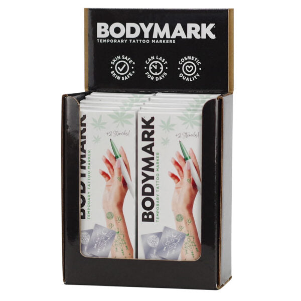 A retail display box of BODYMARK Temporary Tattoo Markers, showing multiple individual packets of markers inside a black cardboard counter display.