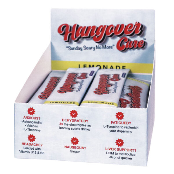A retail display box of 'Hangover Cure' lemonade tablets, showing several individual white packets with red and black lettering inside a white cardboard display unit with red text and icons.