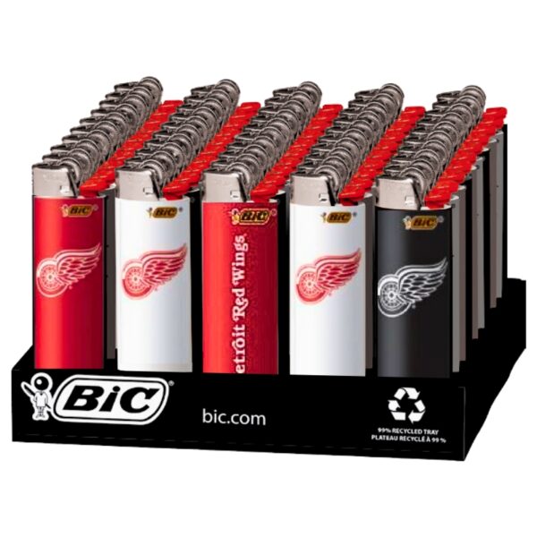 A retail display of BIC lighters featuring Detroit Red Wings team designs, including red, white, and black versions with the team logo and 'Detroit Red Wings' text, set on a branded black stand.