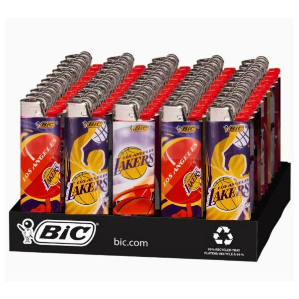 A retail display tray filled with BIC Los Angeles Lakers plastic lighters. The lighters feature purple, yellow, and red Lakers graphics, and the display tray itself is black with BIC branding.