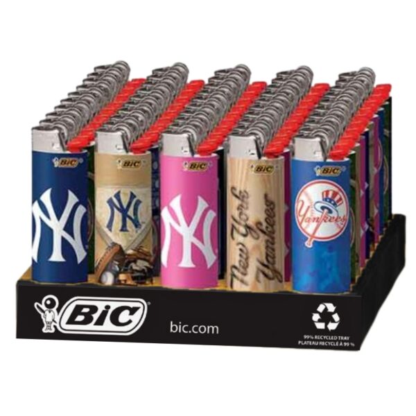 A retail display tray filled with BIC New York Yankees themed lighters. The display features multiple lighter tops in blue, beige, pink, and red, each printed with the New York Yankees logo and name.