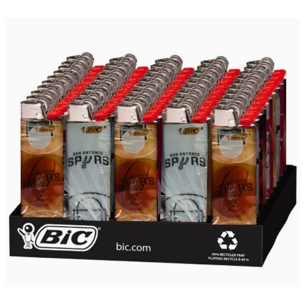 A retail display tray filled with BIC San Antonio Spurs plastic lighter packs. The display base is black with BIC branding, and the packs show the San Antonio Spurs logo and red BIC caps.