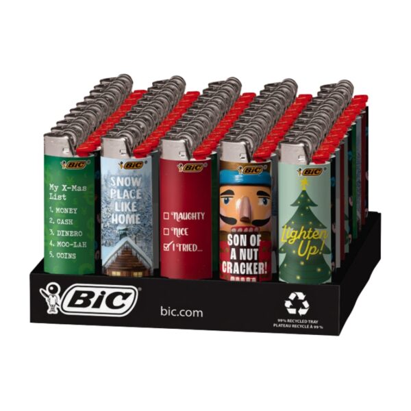 A retail display tray filled with BIC lighters, each featuring a different holiday-themed design including a green 'My X-Mas List' lighter, a blue 'SNOW PLACE LIKE HOME' lighter, a red 'NAUGHTY' lighter, a red 'SON OF A NUT CRACKER!' lighter, and a green 'Lighter Up!' lighter.