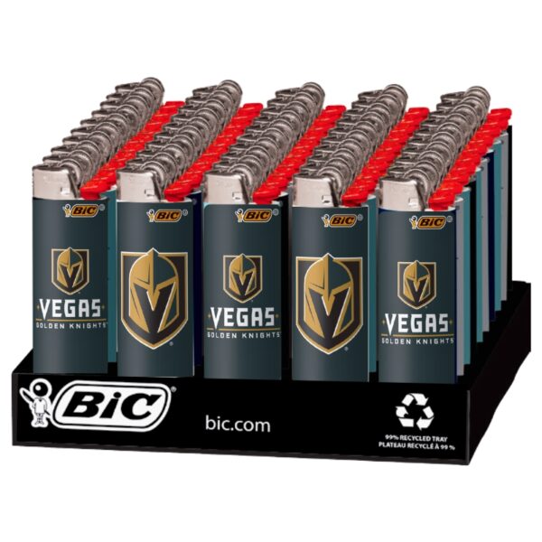 A retail display tray filled with BiC Vegas Golden Knights branded lighter-style batteries. The batteries have dark teal-blue bodies with gold and white Vegas Golden Knights logos, red tops, and silver metal tops, arranged in rows on a black display base.