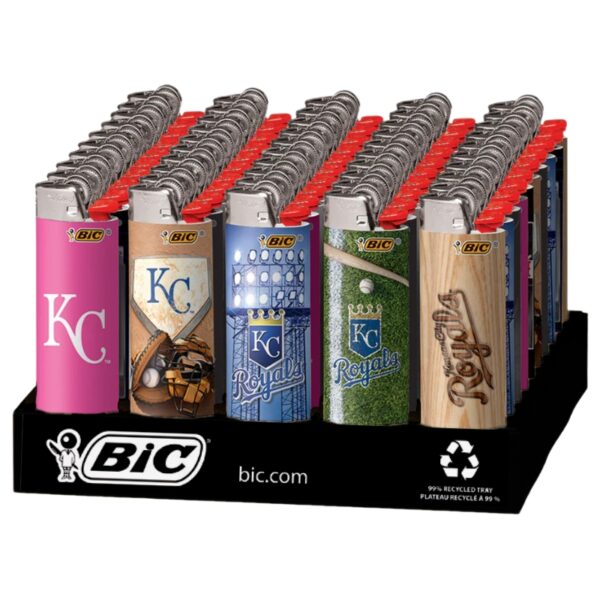 A retail display tray holding multiple BIC lighters with Kansas City Royals themed designs, including team logos and baseball motifs, on a white background.