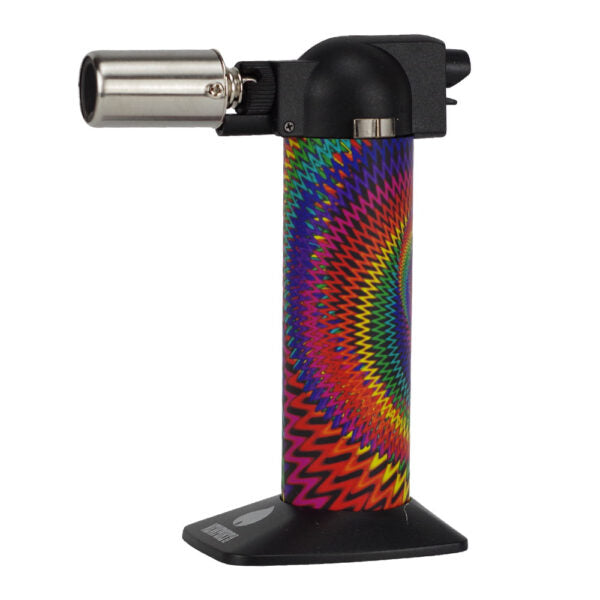 A tabletop torch lighter with a black plastic top and base, featuring a vibrant rainbow spiral pattern on the body, set against a plain white background.