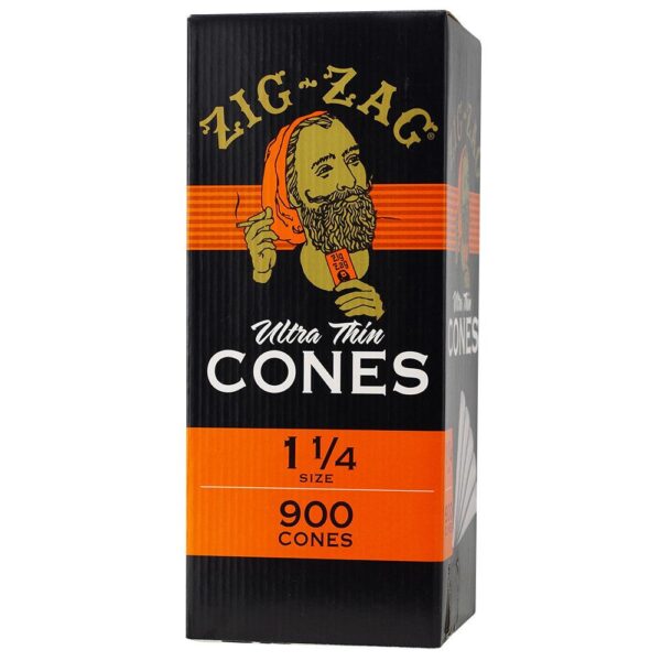A tall rectangular box of Zig-Zag Ultra Thin Cones, size 1 1/4, containing 900 cones. The packaging is black with bright orange stripes and features a vintage-style illustration of a bearded man wearing an orange turban and holding a cone.