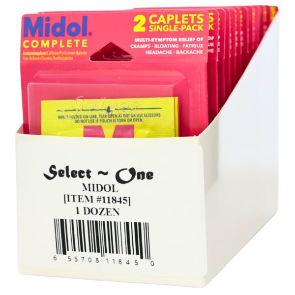 A white cardboard display box containing multiple pink and yellow Midol Complete single-pack caplets packets, with the front packet fully visible and additional packets fanned behind it.