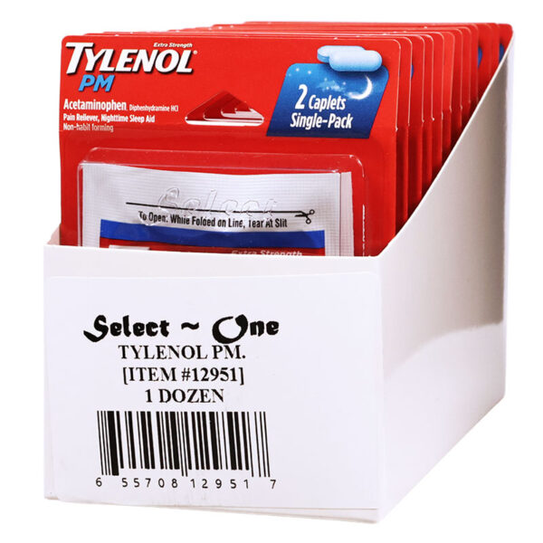 A white cardboard display box filled with red and white Tylenol PM single-pack caplet packets, with the front label reading 'Select One TYLENOL PM. [ITEM #12951] 1 DOZEN'.