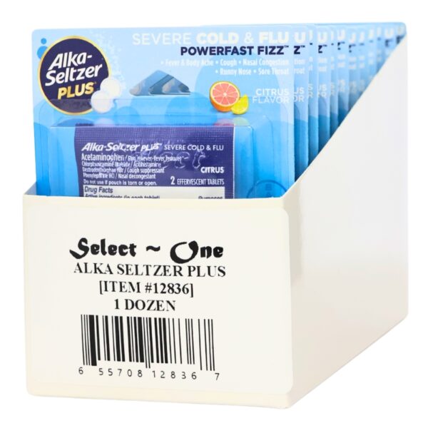 A white cardboard display box holding multiple Alka-Seltzer Plus packets, with the front label reading 'Select One ALKA SELTZER PLUS 1 DOZEN' and a barcode. The packets are predominantly blue with citrus graphics.