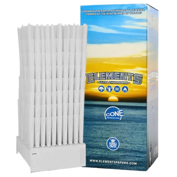 A white plastic cone holder filled with white rolled papers stands next to its retail box. The box features a blue and yellow sunset ocean design with the brand name 'Elements' and 'Cone' visible.