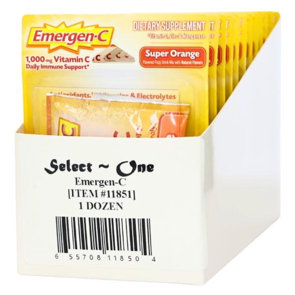 A white plastic display box holding multiple yellow Emergen-C packets, with the front packet showing the Emergen-C branding and flavor text. The box is labeled 'Select ~ One Emergen-C [ITEM #11851] 1 DOZEN' with a barcode.
