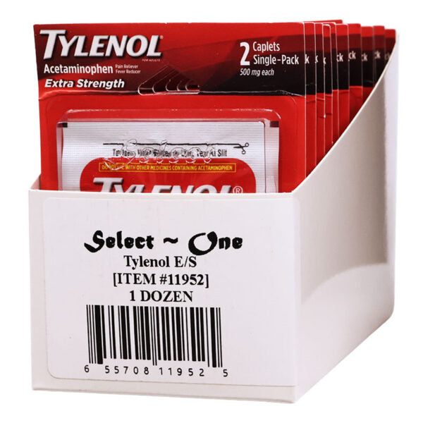 A white retail display box filled with Tylenol E/S acetaminophen single-pack caplets. The front label reads 'Select One Tylenol E/S [ITEM #11952] 1 DOZEN' with a barcode, and the packs inside are red, white, and black.