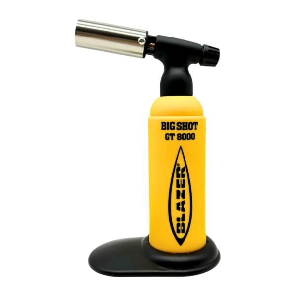 A yellow and black K&N brand blowtorch with a silver metal nozzle, standing on a black base against a white background.