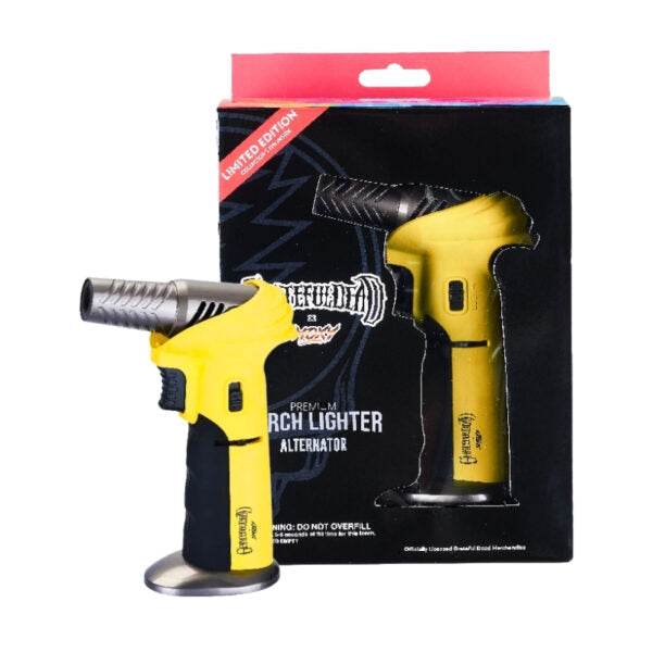 A yellow and black torch lighter shown in front of its retail packaging box, which is black with a red 'Limited Edition' banner. The lighter has a metallic silver nozzle and base.