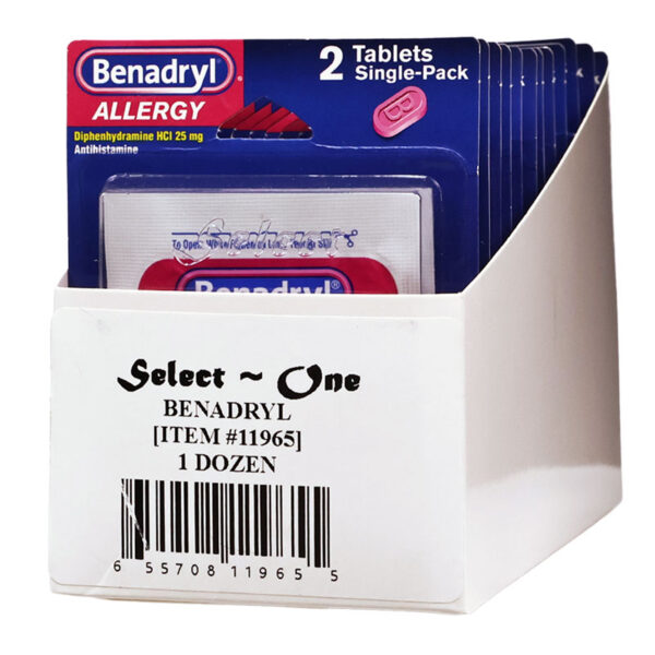 Benadryl Allergy 2 Tablets Single-Pack display box containing one dozen single-serve allergy medicine packets. The front packet shows blue packaging with red Benadryl branding and pink tablets, while the white display bin reads 'Select One BENADRYL 1 DOZEN'.